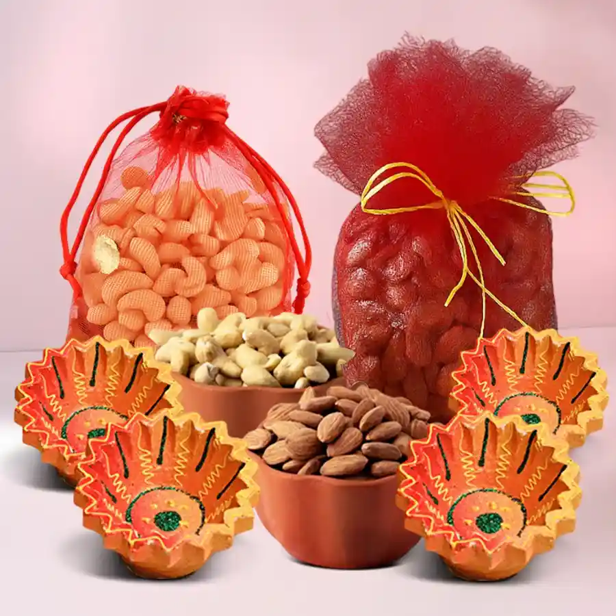 A beautifully arranged Diwali gift hamper featuring 250g each of premium cashews and almonds in elegant net potlis, accompanied by four handcrafted clay diyas, symbolizing the festive spirit of Diwali.