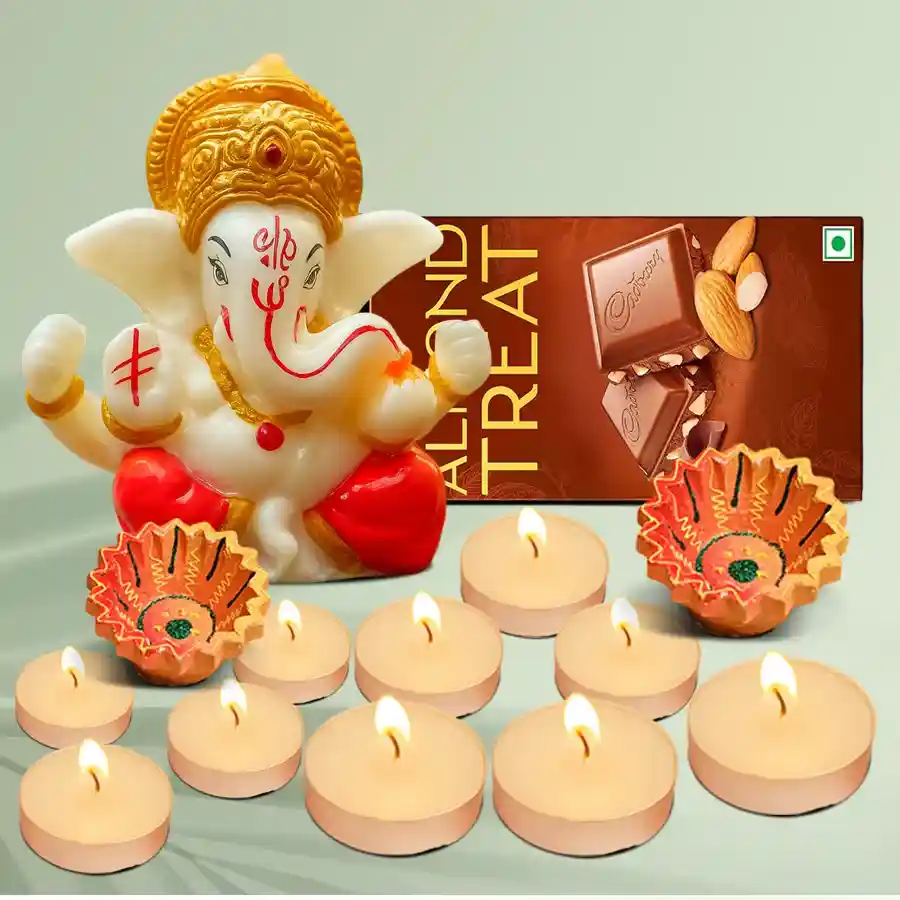 Festive Glimmers Gift Hamper featuring a Glowing Ganesh Idol, Designer Clay Diyas, scented T-Light candles, and Cadbury Temptations Almond Treat.