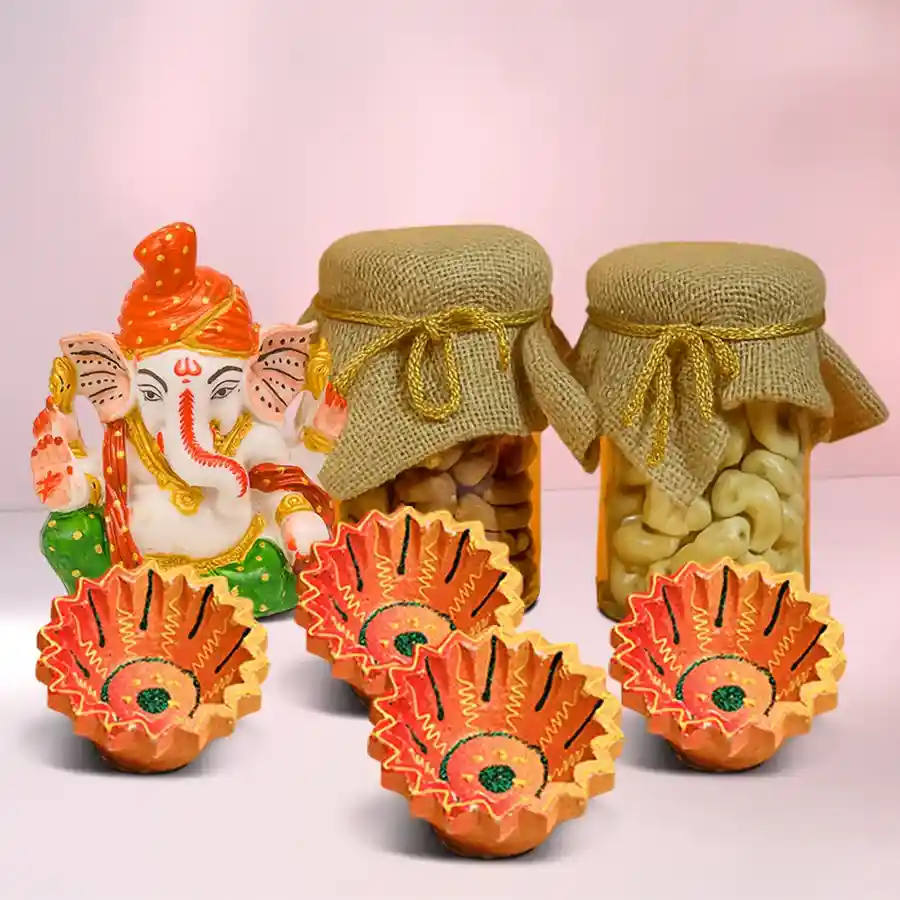 Radiant Glow Diwali Hamper featuring a Polyresin Pagdi Ganesh Idol, designer jute-tied glass jars with cashews and almonds, and four clay diyas