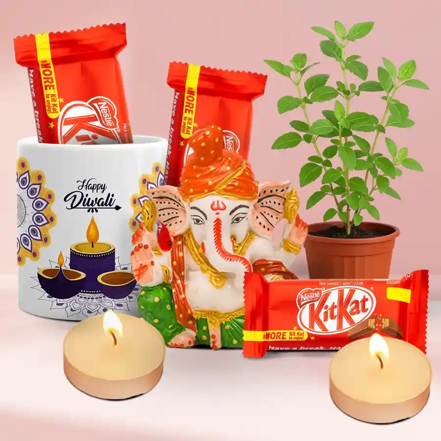 Luminous Diwali Blessings Hamper featuring a Polyresin Pagdi Ganesh Idol, a fresh Tulsi plant, a Happy Diwali Ceramic Mug, Nestle KitKat chocolates, and scented T-light candles arranged in a festive display.