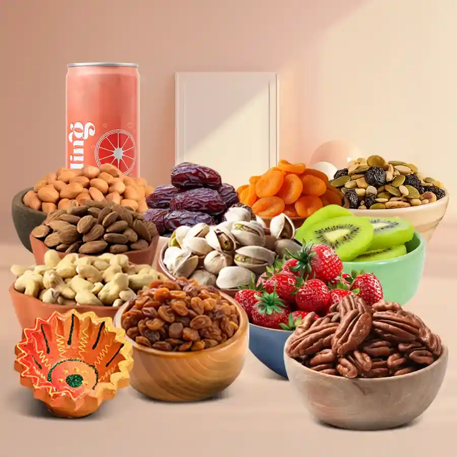 A beautifully arranged Diwali feast hamper featuring a diya, a variety of premium nuts, dried fruits, fresh kiwis, cranberries, dates, and a juice can, all presented on a designer tray.
