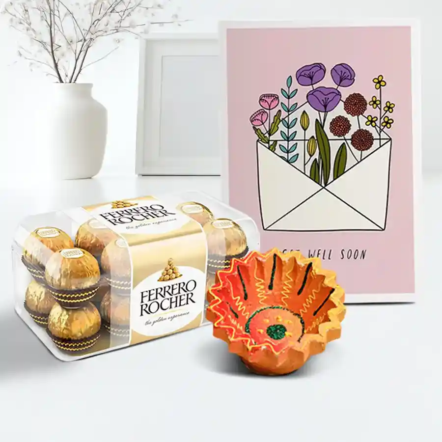 A beautifully crafted Diya alongside a box of 16 Ferrero Rocher chocolates, styled for Diwali celebrations, with a message card.