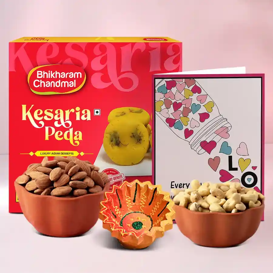 Festive Diwali hamper featuring a beautifully crafted Diya, 500g of Kesaria Peda, 100g each of almonds and cashews, and a message card.