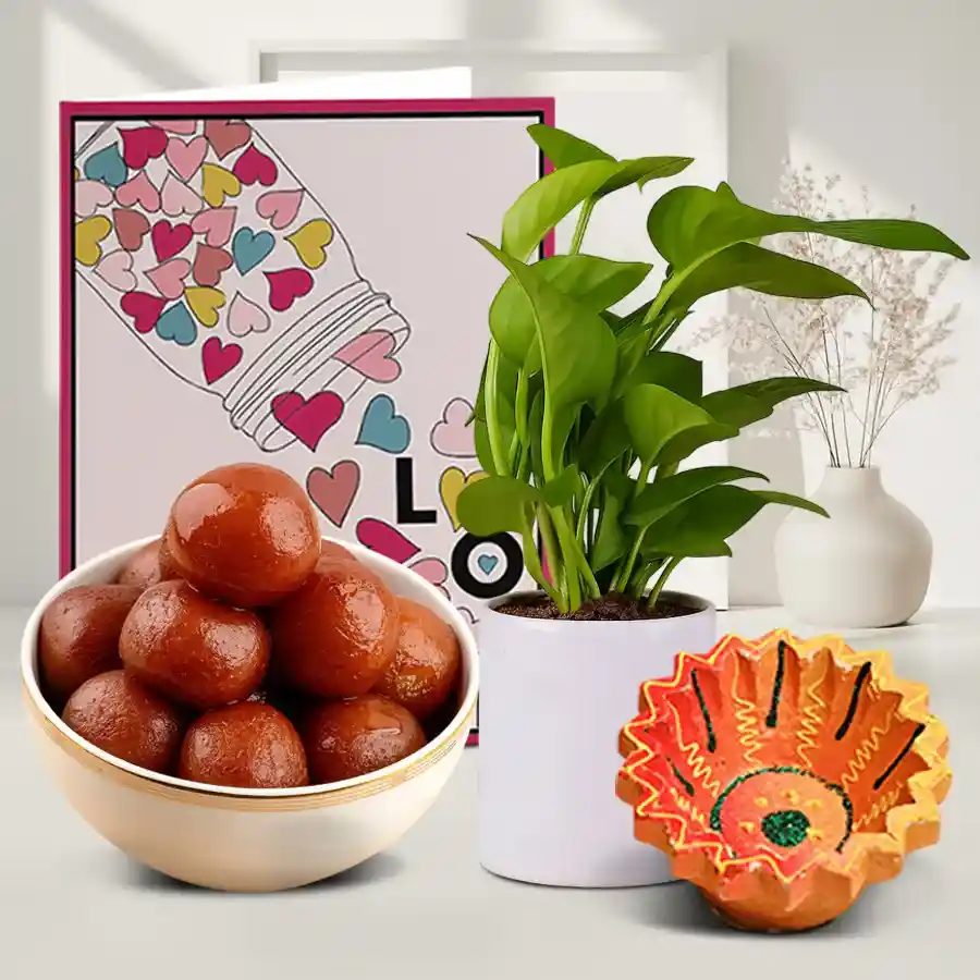 Personalized Diwali greeting hamper featuring a Diya, a Money Plant in a stylish pot, and a box of Gulab Jamuns, along with a message card for personalization.