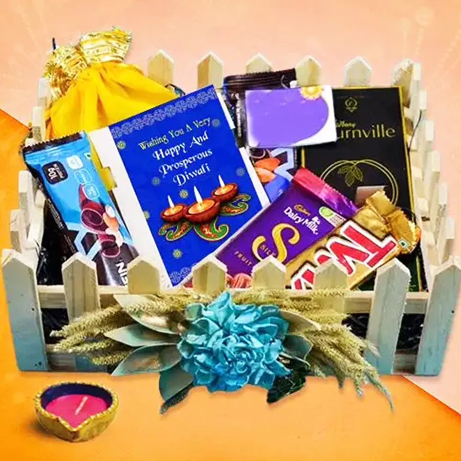 Gourmet Treats Diya and Goodies hamper featuring a decorative diya, assorted chocolates, and granola, beautifully packaged for Diwali celebration.