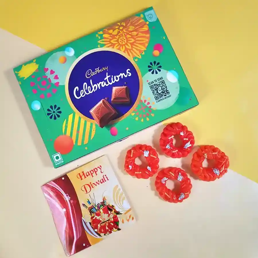Magical Diwali Hamper with Cadbury Celebrations chocolates, Imarti-shaped candles, and a Happy Diwali card