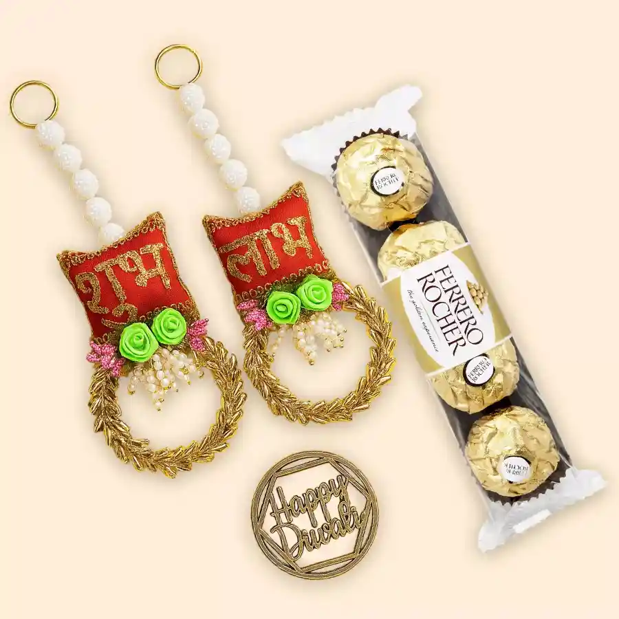 Gift set featuring four Ferrero Rocher chocolates and two Shubh Laabh artisanal hangings on a decorative background.