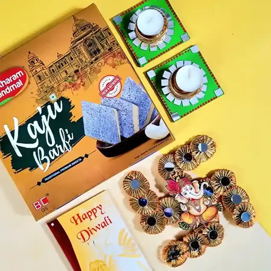 Delightful Diwali Assortment featuring Kaju Katli, T-Light candles, Swastik Ganesha door hanging, and a Happy Diwali greeting card