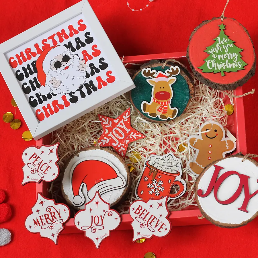 Colorful Christmas gift set featuring a decorative frame, sliced log hangings, fridge magnets, and unique ornaments, all arranged festively.