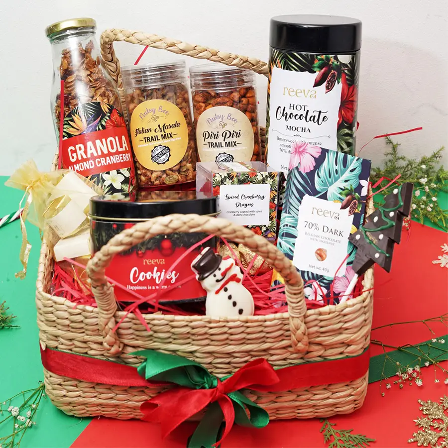Festive Fusion Nutty N Chocolate Medley hamper with granola, trail mixes, dark chocolate bar, salted cranberry dragees, handcrafted chocolates, cookies, chocolate snowman, and Christmas tree lollipop
