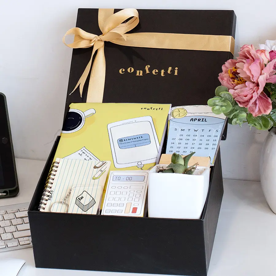 Thoughtful Journals Gift Set including a 200-page A5 journal, A6 spiral notebook, sticky notes, a 2024 calendar, an Escape keychain, a succulent in a white pot, and a reusable black confetti box arranged together in a stylish presentation.