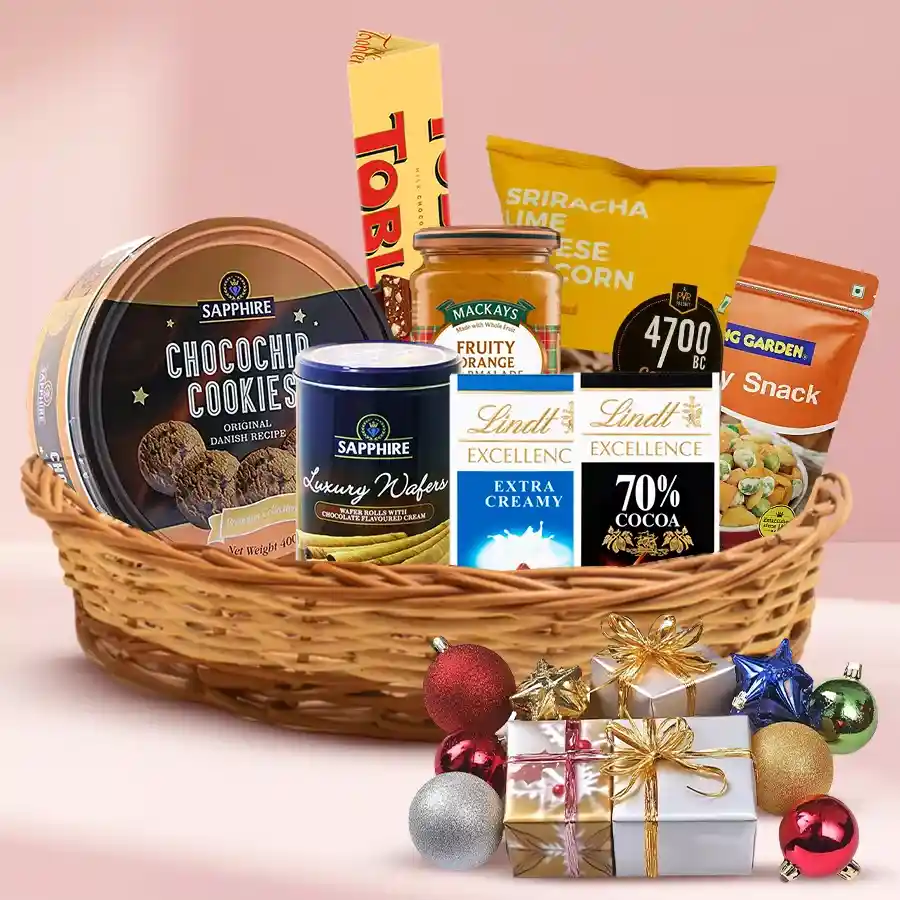 Exotic Christmas Cookies and Chocolates Hamper filled with assorted treats like cookies, chocolates, popcorn, and marmalade in a festive box.