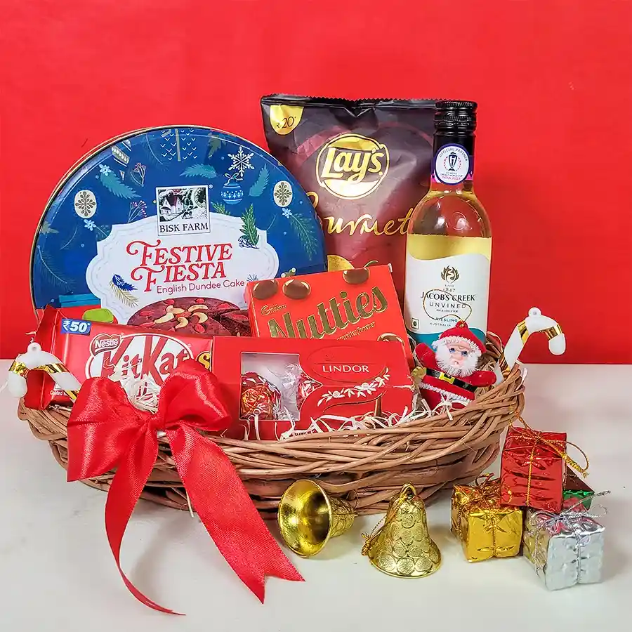 Ultimate Christmas Treats Basket filled with festive goodies including non-alcoholic Riesling, Dundee cake, gourmet chips, chocolates, and a decorative box, all beautifully gift-wrapped.