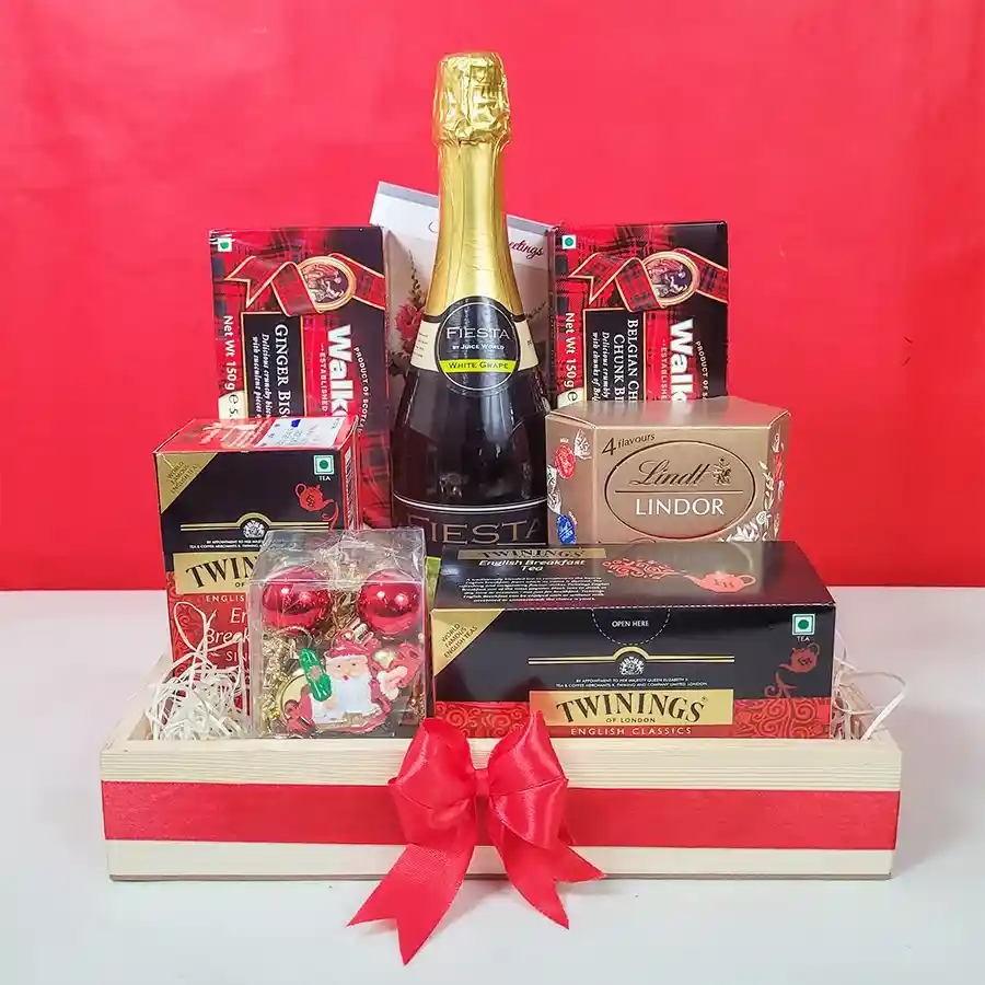 Festive Gourmet Treats and Sips Hamper with sparkling juice, chocolates, biscuits, tea, and Christmas decorations