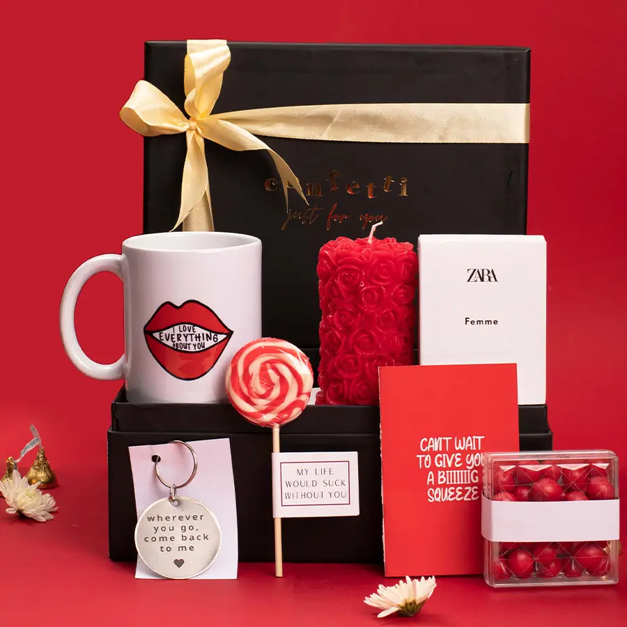 Valentine's Day gift hamper featuring a mug, candle, cherry dragees, lollipop, perfume, and keychain in a black signature box.