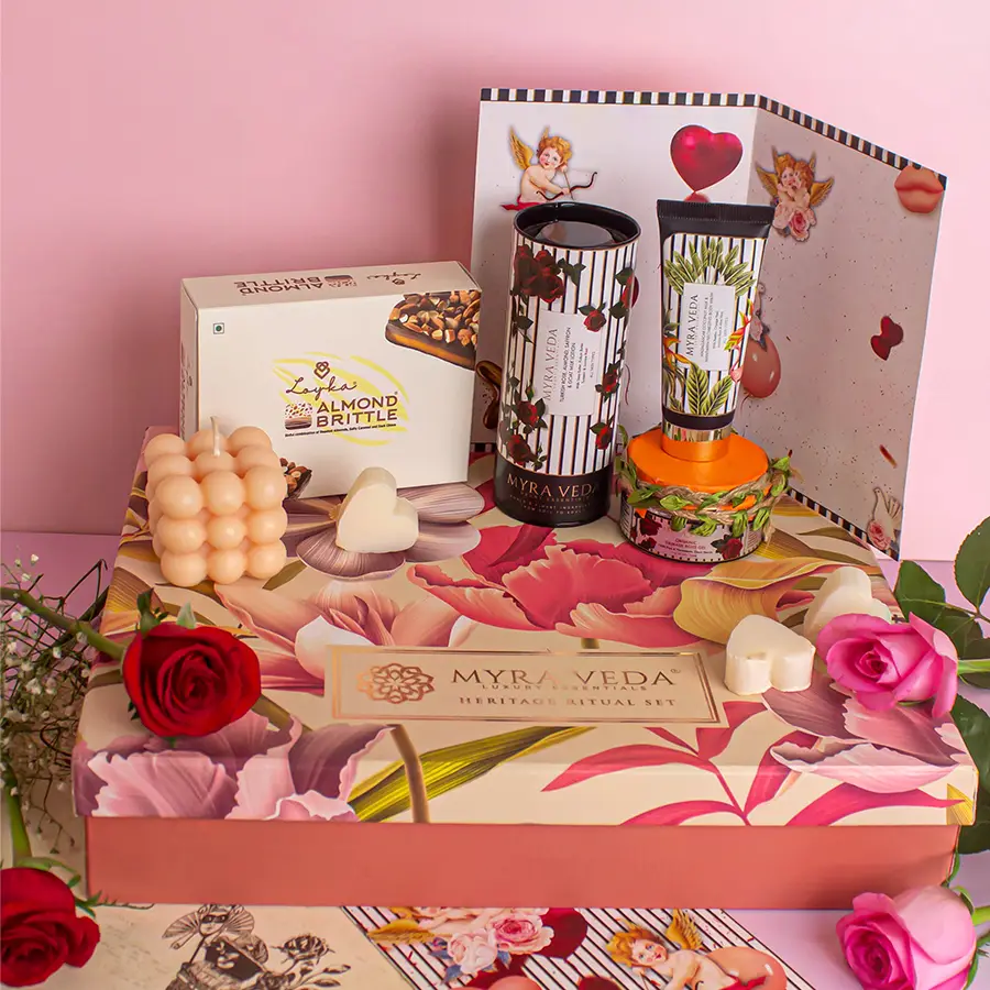 A beautifully curated Valentine's gift box featuring a vegan soy wax candle, almond brittle chocolates, luxurious lotions, a coconut body wash, organic gels, and a handwritten card.