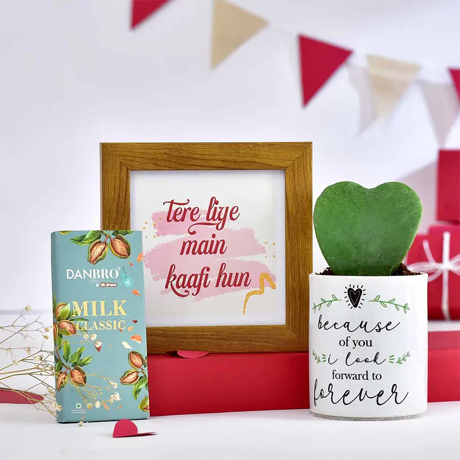 Heartfelt Surprises Gift Set featuring a personalized photo frame, Hoya heart plant in a customized planter, and a handmade dark chocolate bar arranged beautifully