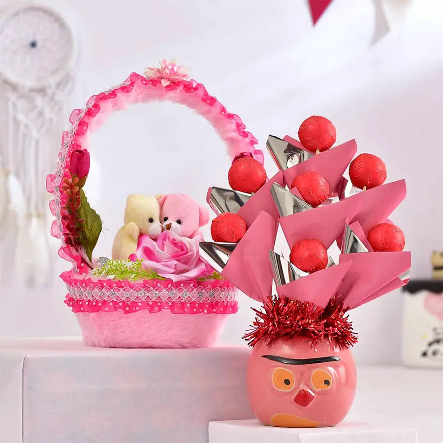 Delightful Valentine's Day gift combo featuring homemade chocolates in a pink ceramic pot and a 9" pink couple soft toy basket.