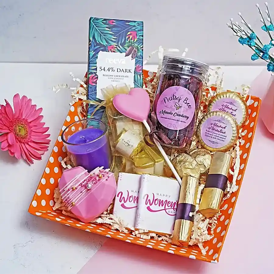 Deluxe Chocolate Lovers Gift Box featuring dark Belgian chocolate bars, heart-shaped hot chocolate piñata, silky truffles, almond rocks, masala cranberry bottle, and heart-shaped lollipops arranged elegantly