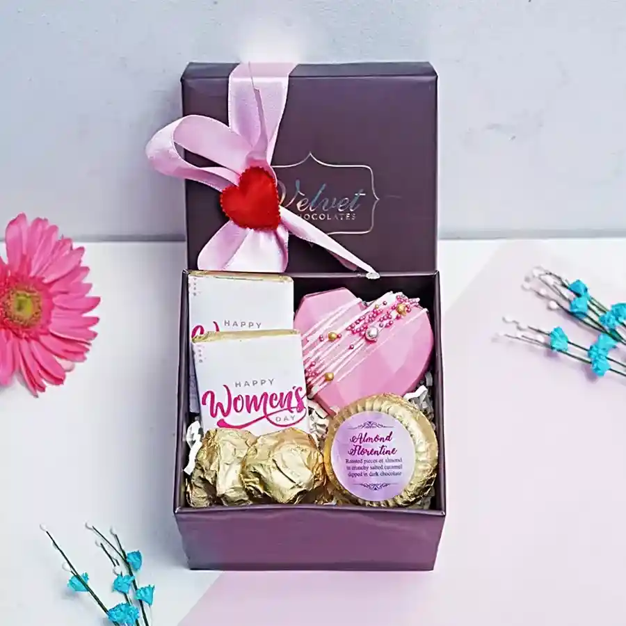 Indulgent Chocolate Treats Hamper featuring a heart-shaped hot chocolate piñata, two chocolate bars, almond rocks, and almond chocolate florentine