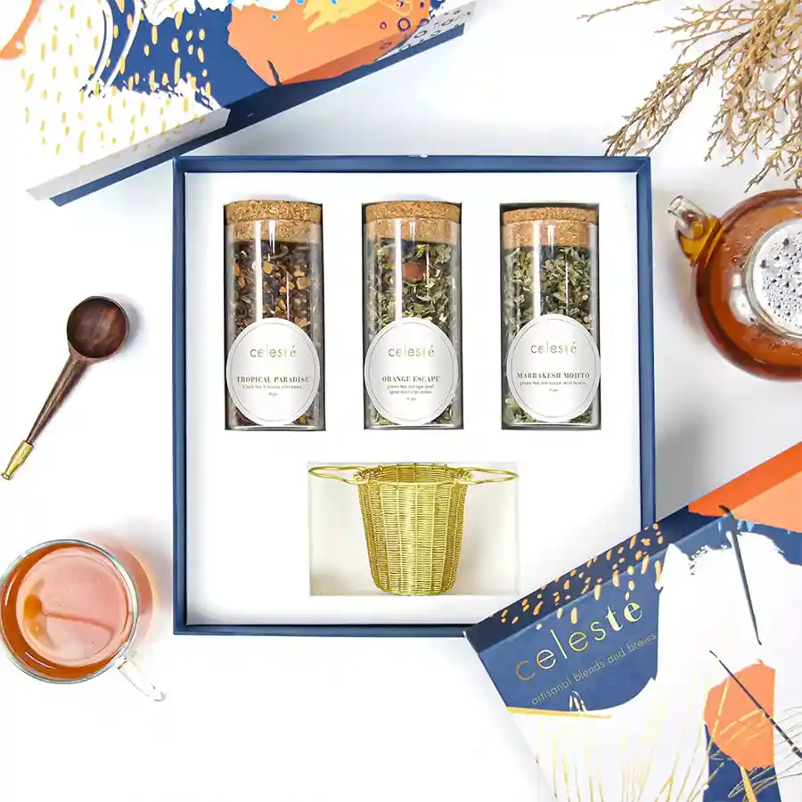 Blissful Tea Ensemble Gift Box featuring Royal Blossom Black Tea, Serendipity Black Tea, Soulful Tango Green Tea, and a stylish tea basket strainer