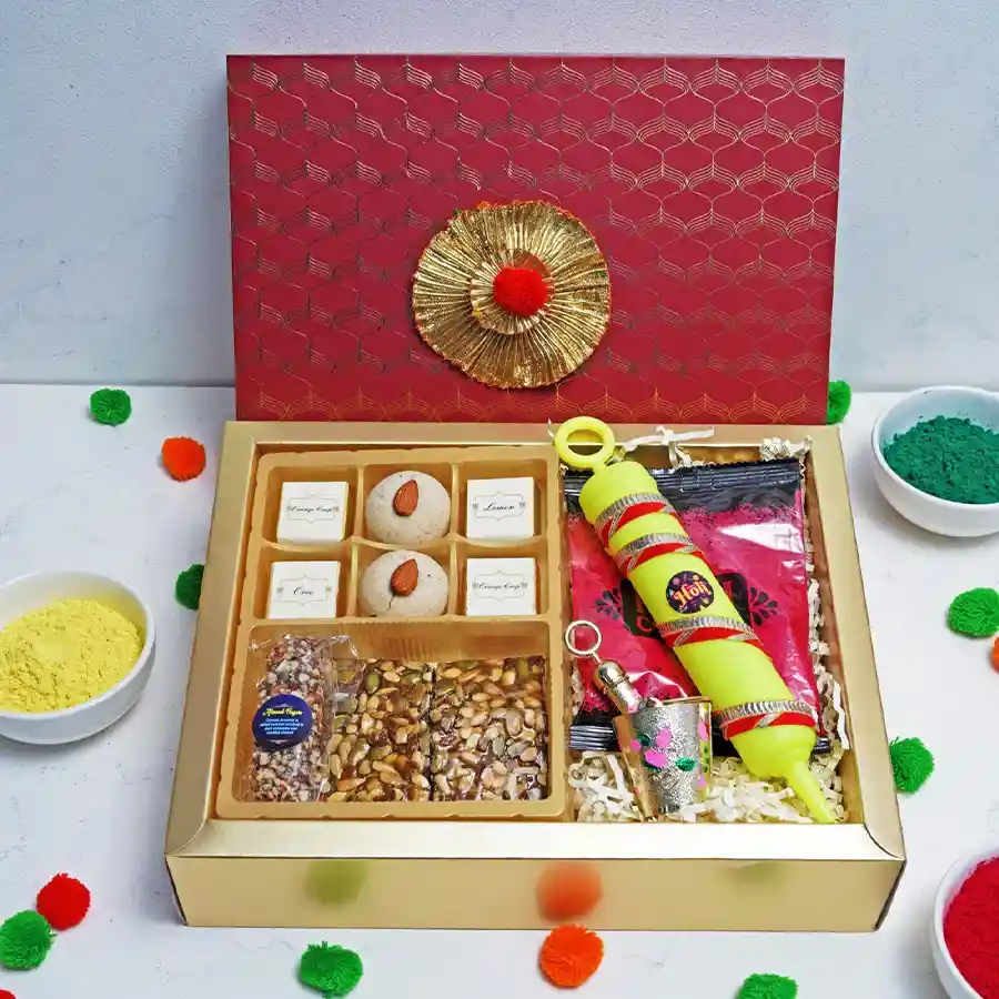 Fabulous Holi Celebrations Gift Set featuring assorted chocolates, Nankhatai, Seeds Squares, Almond Finger, Laddu Gopal Balti, Holi Pichkari, and colorful powder pack