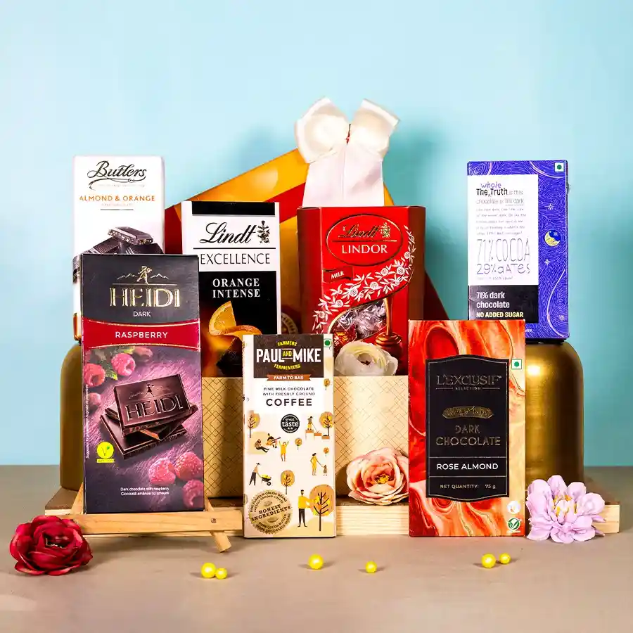 Exquisite dark chocolate gift hamper featuring a variety of premium chocolates including Lindt Lindor, Butlers Almond Orange, Lindt Excellence, Heidi’s Dark Raspberry, and Paul Mike’s Coffee-infused bars elegantly arranged in a decorative box.