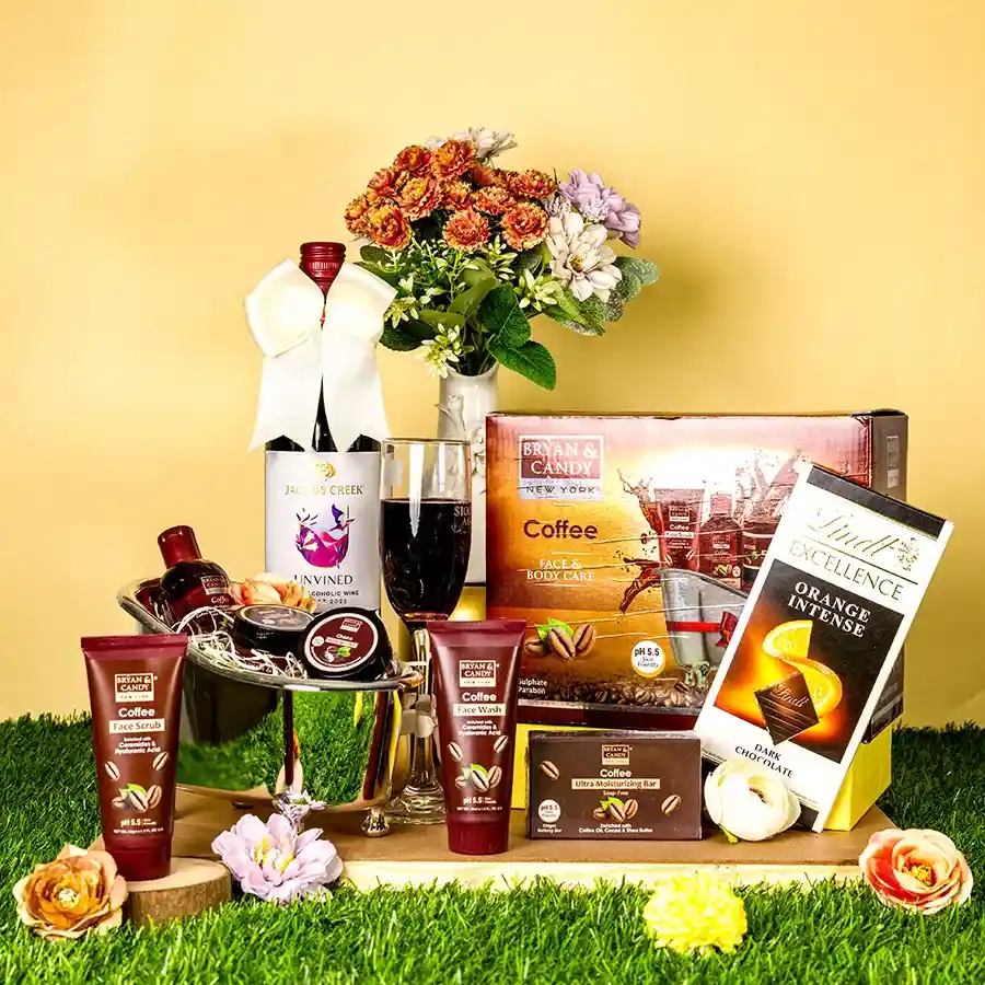 Spa retreat hamper featuring coffee body and face care kit, non-alcoholic red wine, and orange chocolate bar