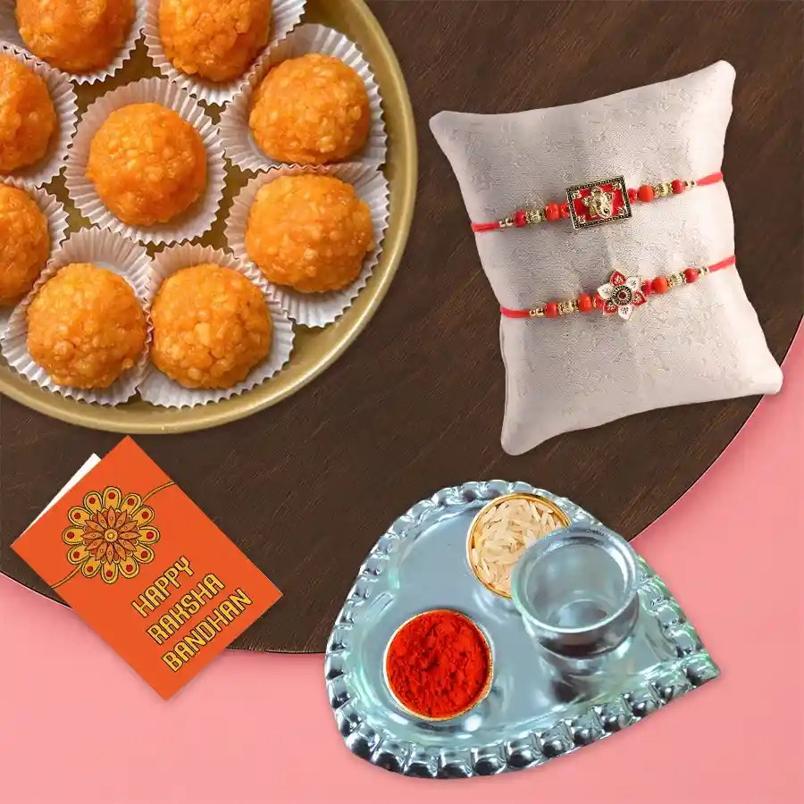 Finest Motichur Laddoo pack with designer stone rakhi set, Roli Tika, Chawal, and personalized Rakhi wishes card for Raksha Bandhan celebration.