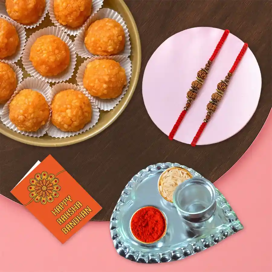 Exquisite Rudraksha Rakhi set with Haldiram Motichur Laddoos, Paan-shaped Puja Thali, Roli Tika, Chawal, and personalized Rakhi message card