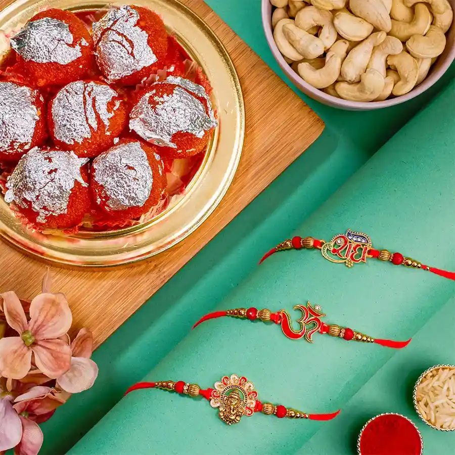 Spiritual Rakhi Set with Ganesha, OM, and Radhe Rakhis, Ghee Laddus, Cashews, and festive accessories