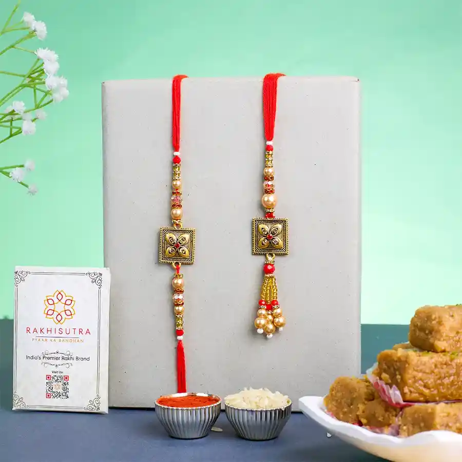 Stylish Kundan Rakhi with a mini milk cake, Roli Tika, Chawal, and a personalized message card for Raksha Bandhan celebration.