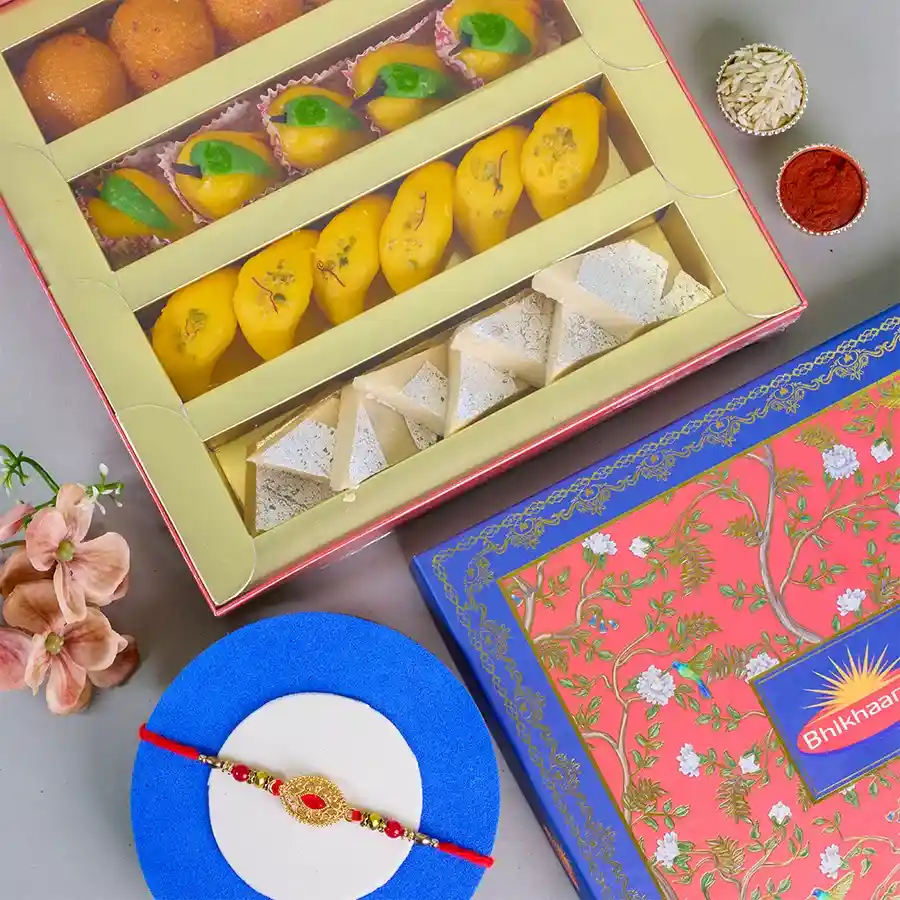 Festive Rakhi Sweet Celebration Combo featuring a Rakhi, a 500g box of assorted Indian sweets, a Roli Tika & Chawal set, and a message card.