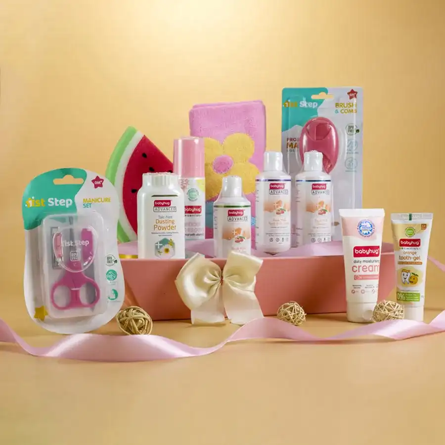 Premium Baby Care Gift Hamper featuring Babyhug essentials, soft pink towel, manicure set, grooming tools, and a reusable designer basket on a neutral background.