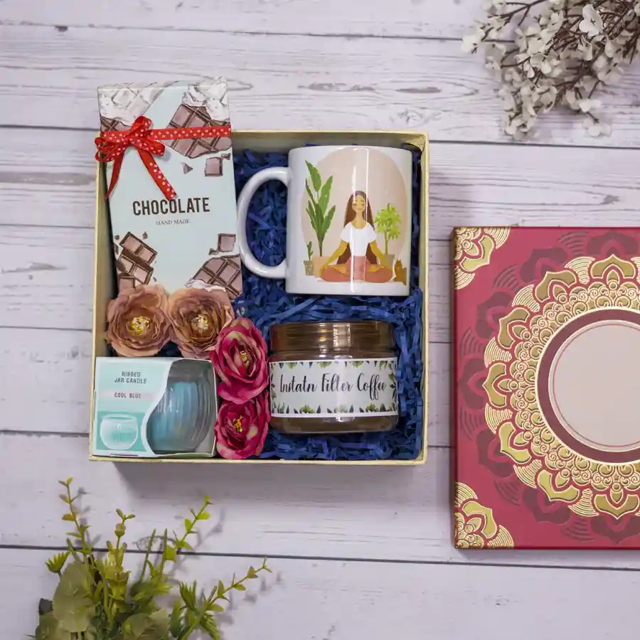 Serene Sips N Treats Set including instant coffee, handmade chocolate bar, yoga-themed mug, ribbed jar candle, and mandala box.