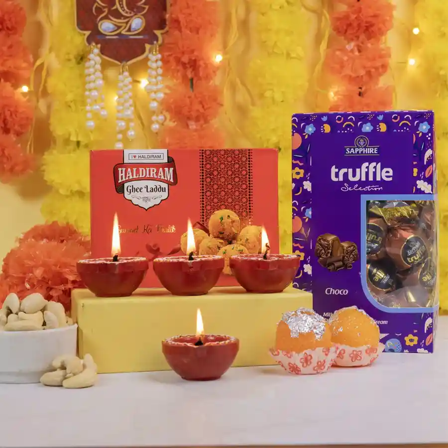 Crunchy Nuts N Sweet Treats Collection featuring Ghee Laddus, Sapphire Truffles, crunchy cashews, Mud Diyas, and Laddu candles.