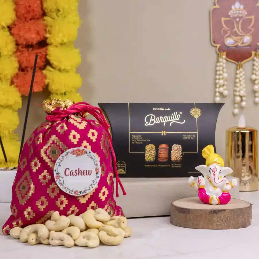 Mukut Ganesh statue with assorted treats including Barquillo Assorted Chocolates and Cashew Potli on a decorative background
