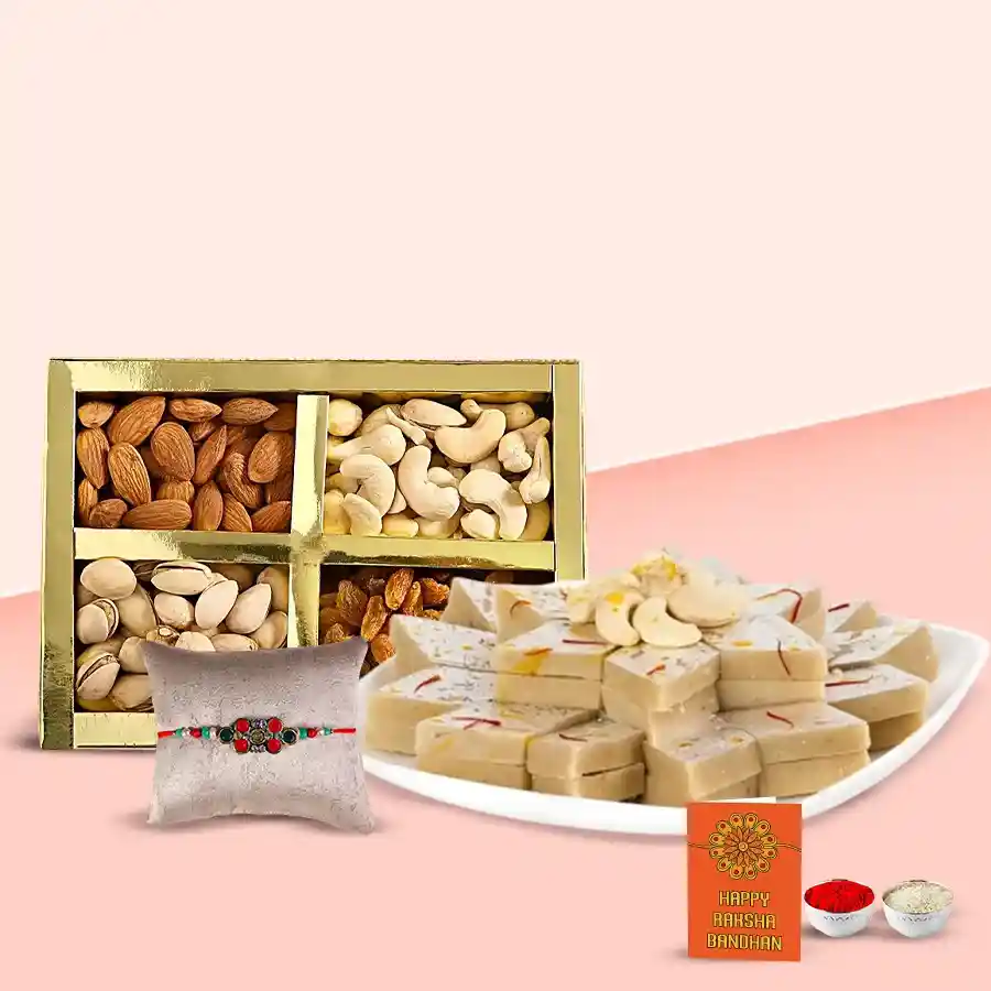 Mixed dry fruits, Kaju Barfi, Rakhi, Roli, Tilak, and Chawal arranged in a festive gift pack for Raksha Bandhan celebration.