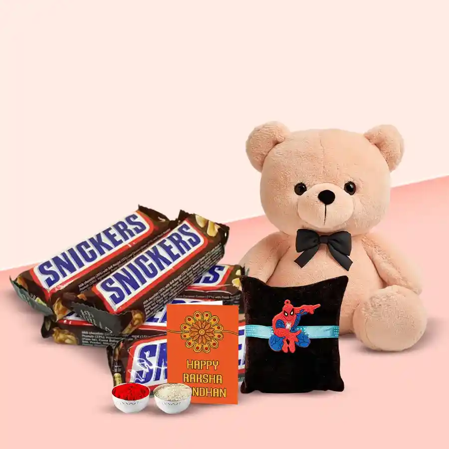 4 Snickers bars, a cute teddy bear, kids Rakhi, Roli Tilak, and Chawal arranged together in a festive setting