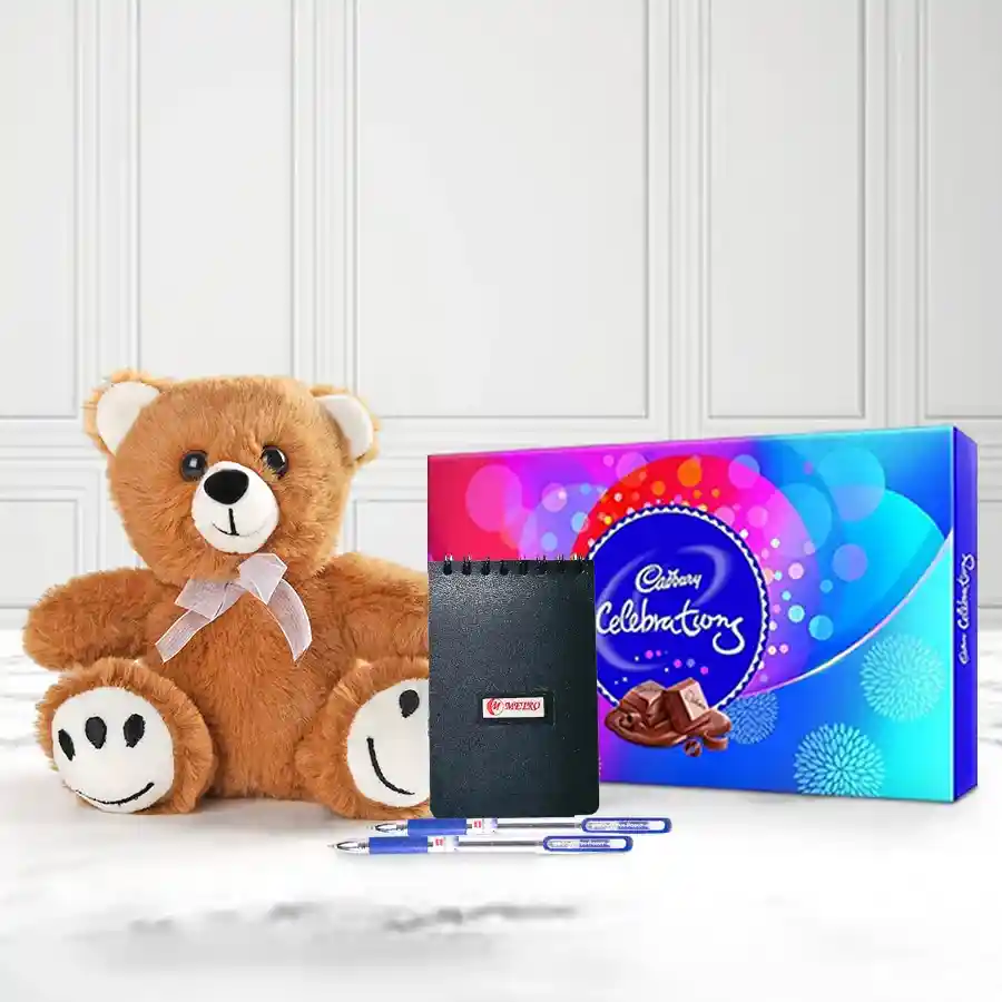 New Year gift bundle featuring stylish ballpoint pens, a 6-inch teddy bear, a pocket diary, and a pack of Cadbury Celebration chocolates.