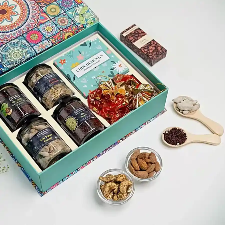 Scrumptious Mukhwas and Chocolates Overloaded Gift Box featuring Paan Gulkand, Aam Papad Pachak, Khatta Chuhara, Saunf Churi, assorted chocolate bars, roasted almonds, and cashews