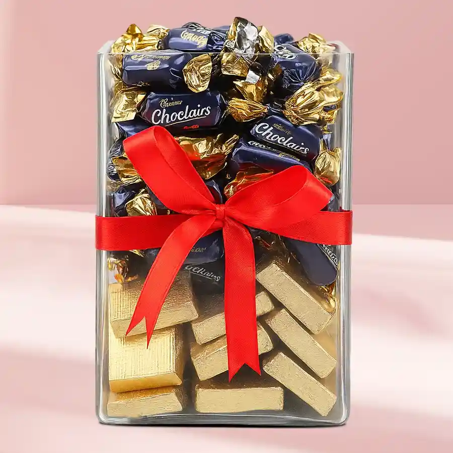 Exquisite glass jar filled with Cadbury Eclairs and handmade chocolates, perfect for Christmas gifting.