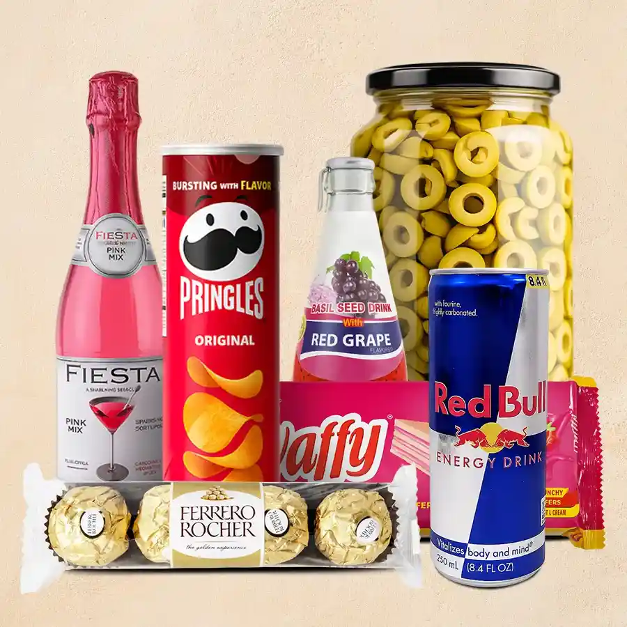 A beautifully arranged Sparkling Christmas Hamper featuring Ferrero Rocher chocolates, Pringles, Waffy Wafers, Red Bull, Fiesta Fruit Juice, Basil Seed Red Grape drinks, and gourmet green olives in a glass jar, all adorned with festive decorations.