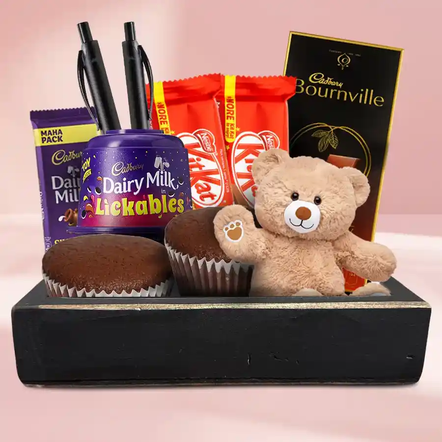 Chocoholic New Year Hamper with chocolate bars, cupcakes, teddy bear, and pens