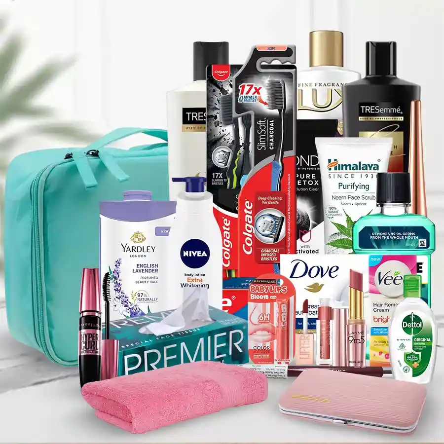 A beautifully arranged gift hamper featuring luxury personal care items including a toothbrush, body wash, face wash, shampoo, conditioner, beauty soap, lotion, lip colors, eyeliner, hair removal cream, mouthwash, sanitizer, shower towel, manicure set, and a storage kit.
