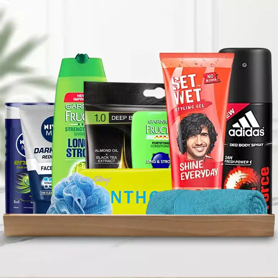 Gift hamper featuring grooming essentials including Adidas Body Spray, Set Wet Hair Gel, Garnier Conditioner & Shampoo, Nivea Shower Gel & Face Wash, Cinthol Soap, a loofah, and a towel in a stylish tray.