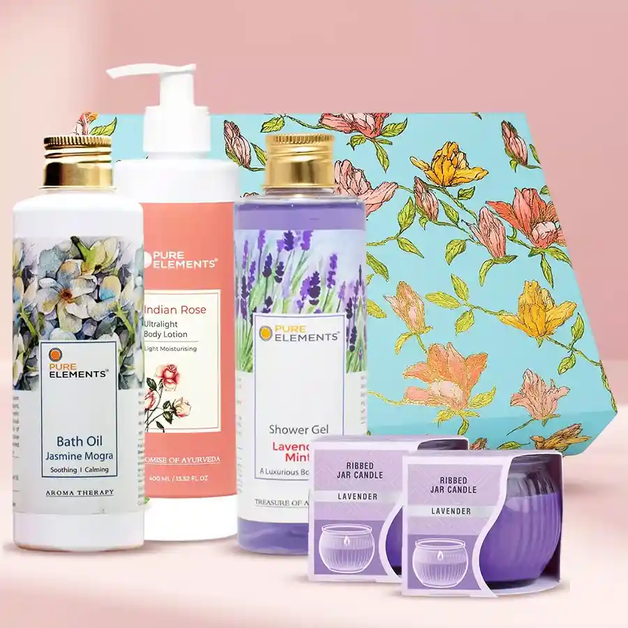 Aromatherapy gift set featuring Indian Rose lotion, Jasmin Mogra bath oil, Lavender Mint shower gel, and Iris Lavender candles arranged elegantly.