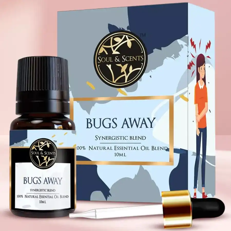Bottles of Bug Free Bliss Bugs Away Essential Oil in a natural outdoor setting surrounded by greenery.