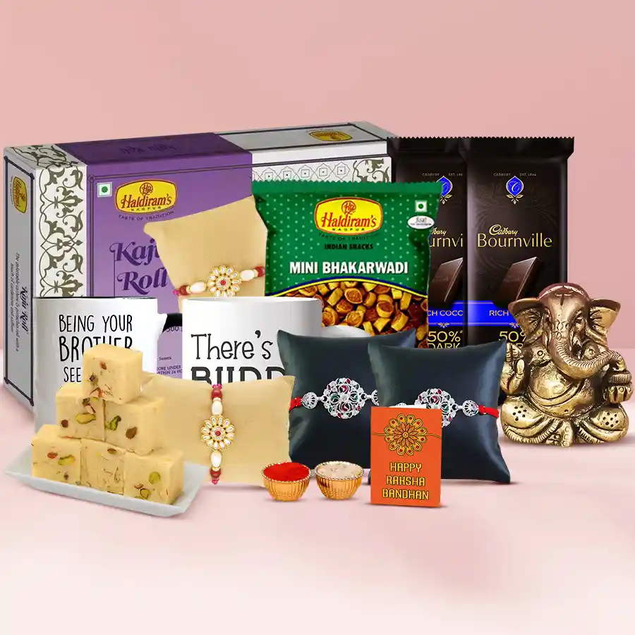 Delightful Rakshabandhan Surprise Hamper featuring silver and pearl rakhis, a Ganesha idol, a designer thali, Haldirams treats, Bournville chocolates, custom mugs, Roli Tilak, Chawal, and a personalized Rakhi card.