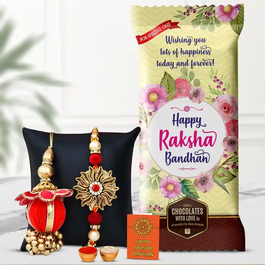 Gift set for Raksha Bandhan featuring a personalized Cadbury Dairy Milk Fruit & Nut chocolate bar, a Bhaiya-Bhabhi Rakhi set, and complimentary Rakhi, Roli, Tika, and Chawal.